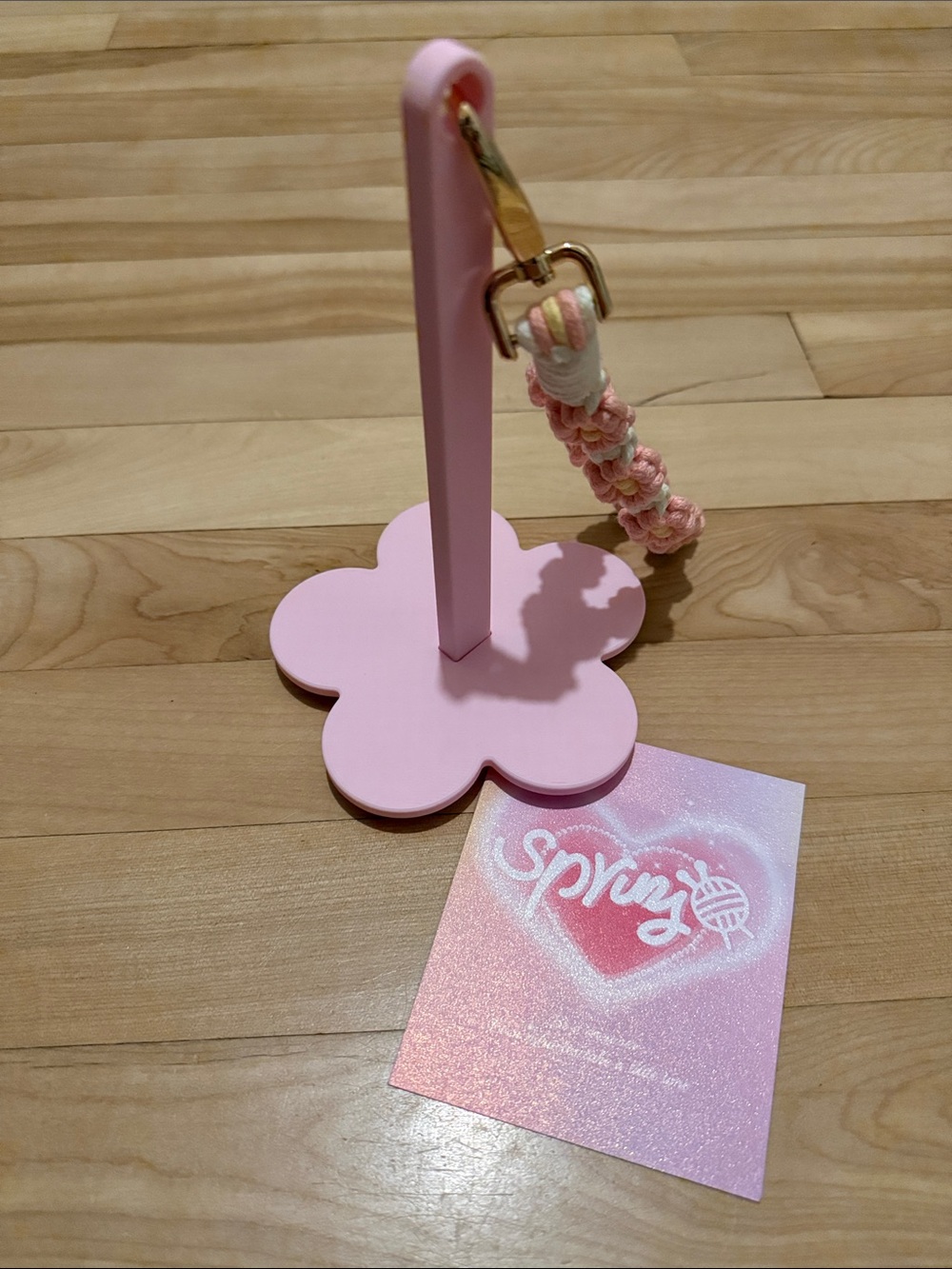 Portable pink flower yarn spinner with braided flower strap